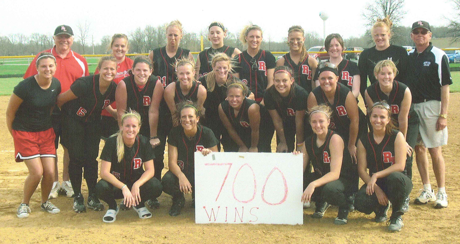 Head softball coach Dave Ellingsworth poses with his team during the 2009-10 season following his 700th career win. 